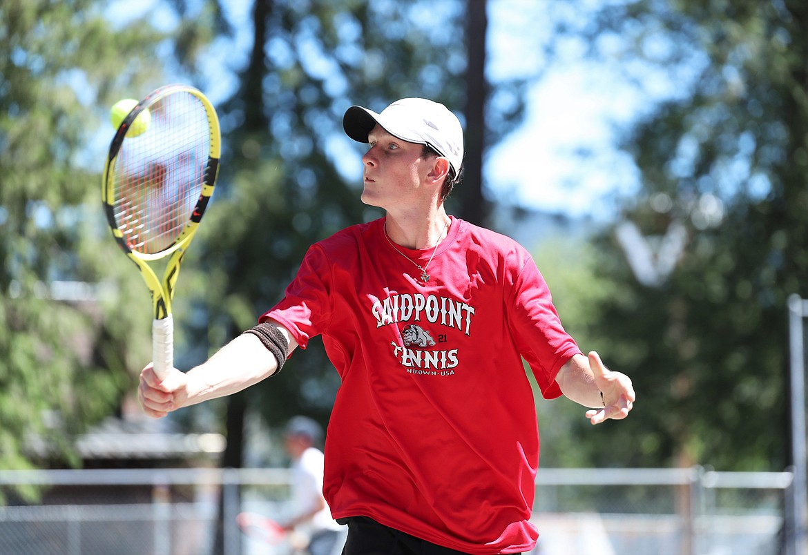 Josh Embree hits a volley at the net on Friday.