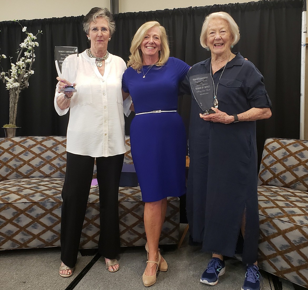 Former Coeur d'Alene Mayor Sandi Bloem, left, North Idaho Alliance CEO Marilee Wallace, middle, and past state legislator Mary Lou Reed stand with the Women of Impact award presented at Friday's women's conference. Photo courtesy Kerri Thoreson.