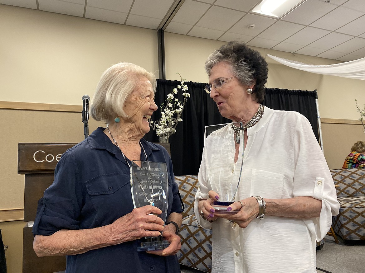 Former Idaho state legislator Mary Lou Reed, left, and past Coeur d'Alene Mayor Sandi Bloem smile with their Women of Impact awards presented at the Onward & Upward with Grace & Gratitude women's conference Friday. (MADISON HARDY/Press)
