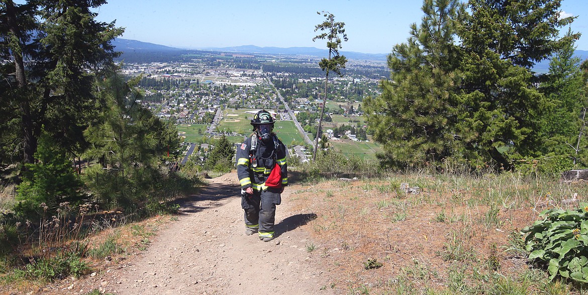 Shay Carlock of Northern Lakes Fire hikes Canfield Mountain on Saturday.