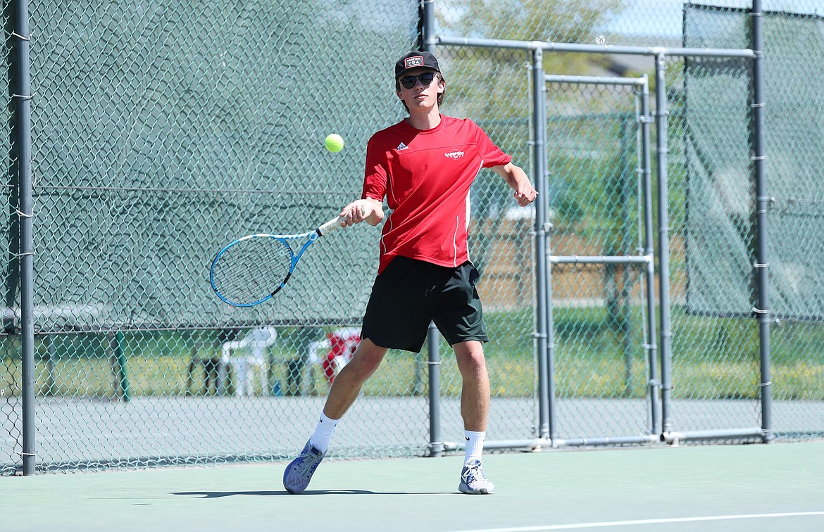 Carter Johnson hits a return during the boys doubles regional championship match on Saturday at Travers Park.
