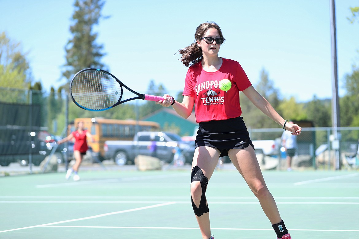 Denali Terry prepares to hit a return during the girls doubles regional championship match on Saturday at Travers Park.