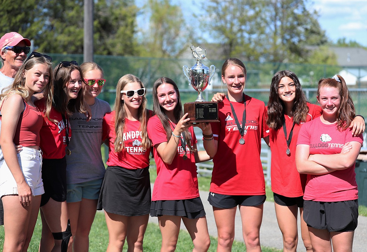 The girls team poses for photos with the regional trophy on Saturday.