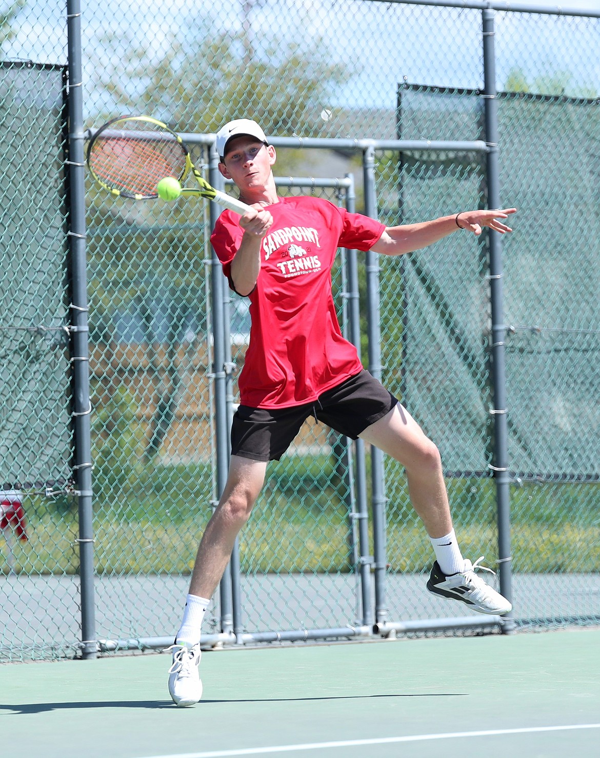Josh Embree hits a return during the boys doubles regional championship match on Saturday at Travers Park.