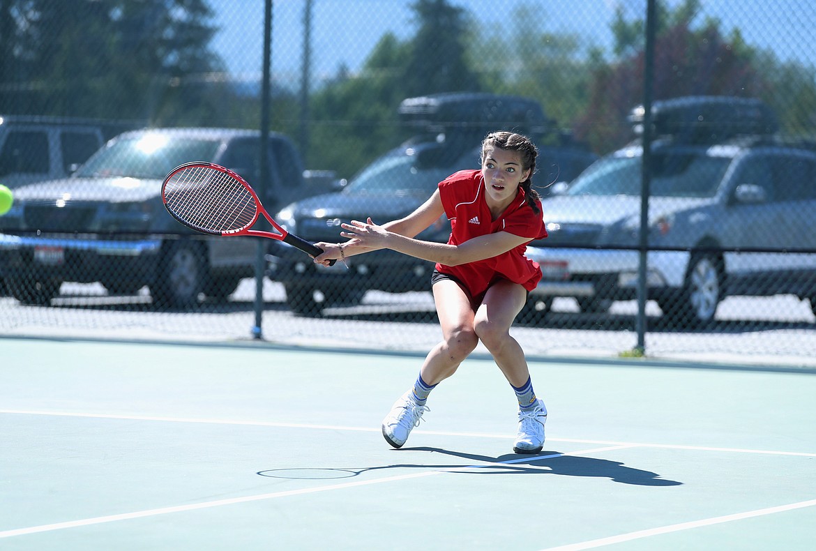 Kailee McNamee gets down low to hit a return during the mixed doubles regional championship match on Saturday at Travers Park.