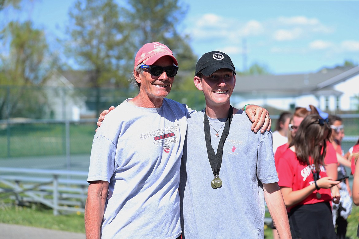 Head coach Kent Anderson poses for a photo with regional champion Josh Embree.