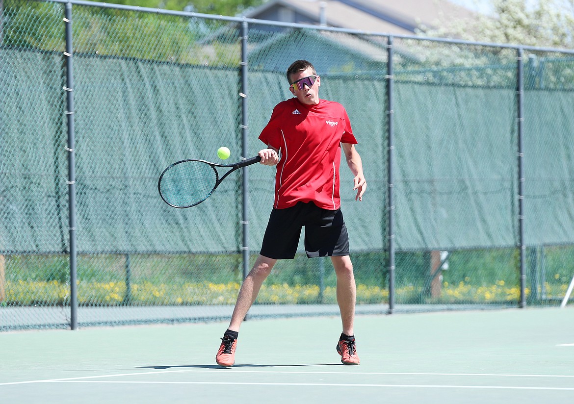 Tyler Korn hits a forehand during the boys doubles regional championship match on Saturday at Travers Park.