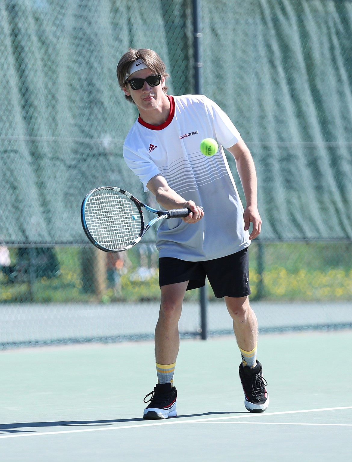 Tyler McNamee returns a serve during the mixed doubles regional championship match on Saturday at Travers Park.