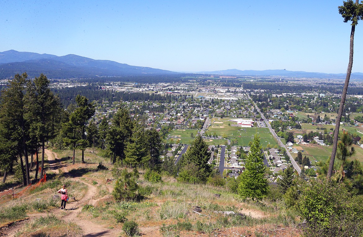 Sue Welch stops hiking up Canfield Mountain and instead enjoys the view on Saturday.