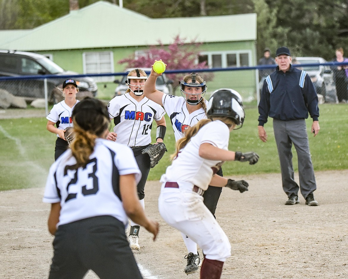 M-A-C players Kooper Page, foreground, Izzy Evans, Liev Smith and Katelyn Young run down a Florence base runner. (Courtesy of Christa Umphrey, Forward Photography)