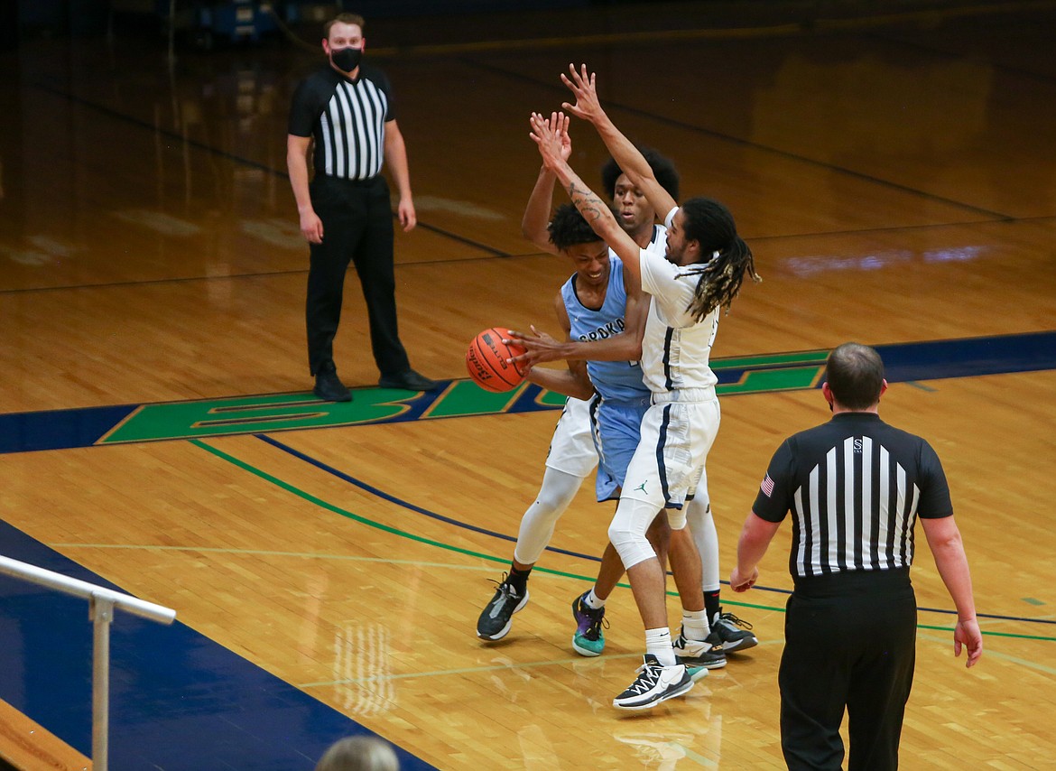 Left to right, DJ Frye and Keenan Miller combine to trap the Spokane player near the sideline in the first half on Saturday afternoon.