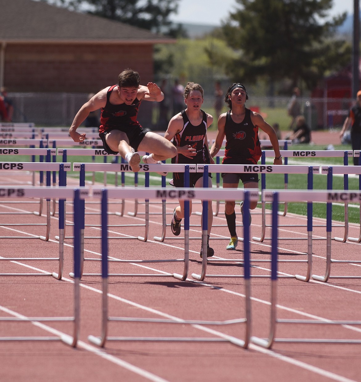 Hot Springs' Kyle Lawson clears a hurdle on his way to a win in the 110-meter event Friday at the 14-C District championship at Missoula County Public School stadium. Lawson also won the pole vault with a personal best 10 feet, 6 inches. (Scott Shindledecker/Valley Press)