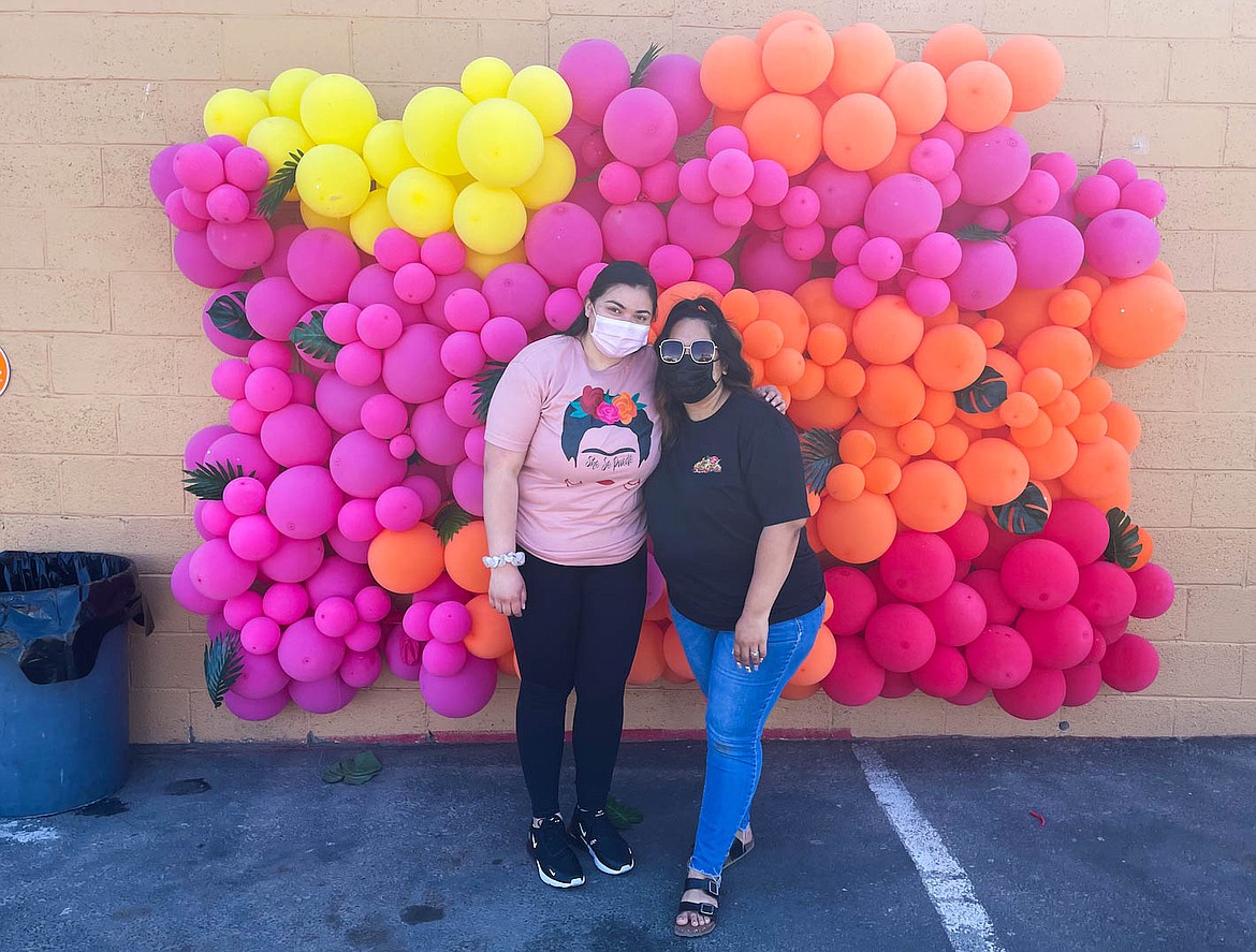 Lydia Pearson (left) of La Pica Chica and Tania Cueves (right) of Andaluz pose before the balloon wall at the She Se Puede Pop Up on Sunday.