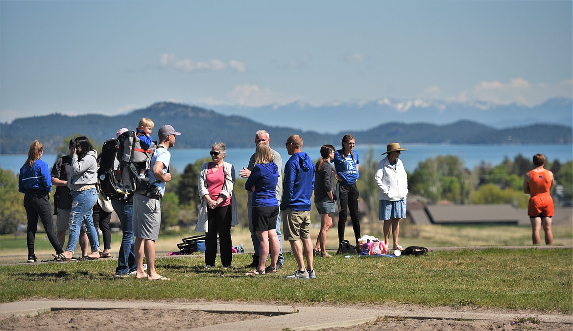 Spectators and athletes mingle at the north end of the oval at Polson High School during the Nelson-Thomas A-B-C track meet Saturday. (Scot Heisel/Lake County Leader)