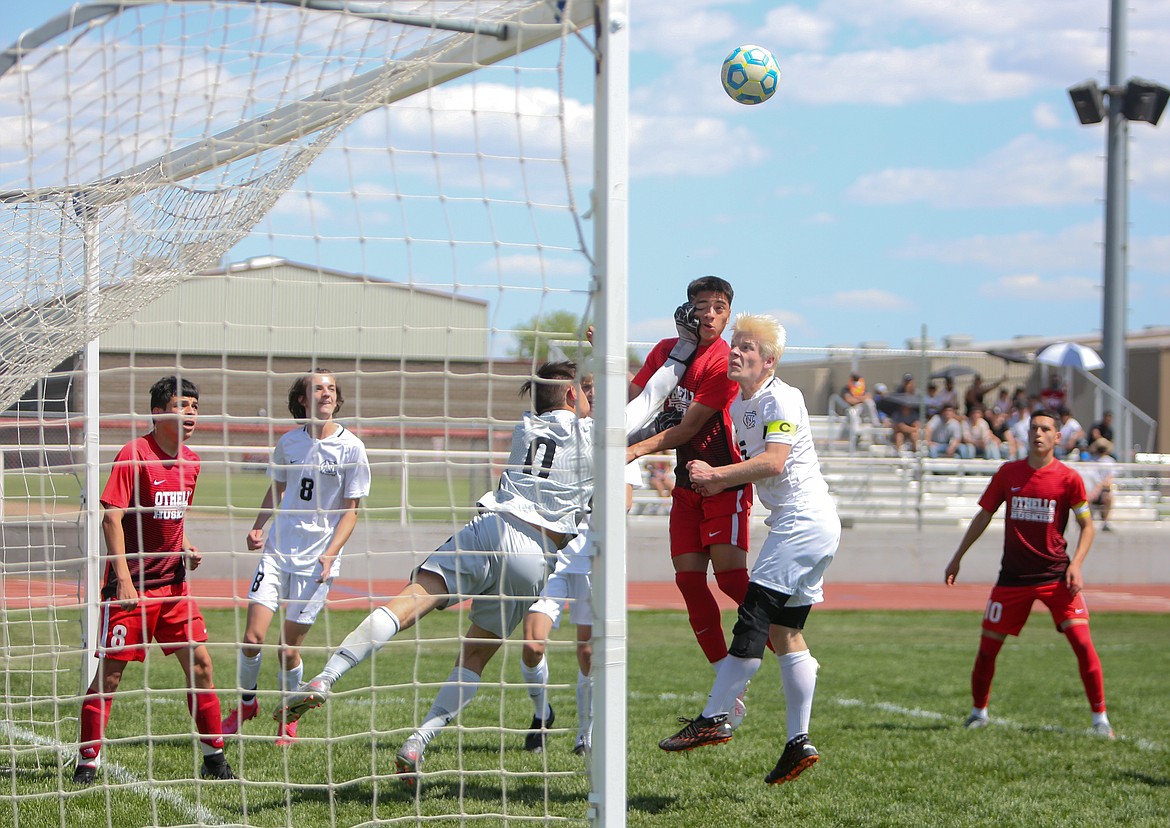 Othello forward Jonathan Alfaro takes a glove to the face inadvertently after going up for a header on a corner kick, resulting in a penalty for the Huskies on Saturday afternoon against North Central High School.