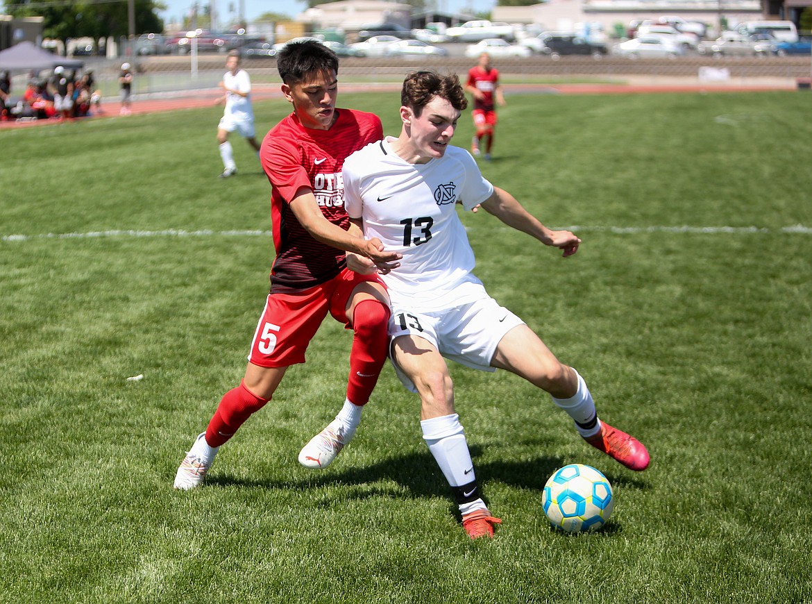 Othello High School's Jonathan Alfaro fights for the ball near the North Central goal in the first half on Saturday afternoon in Othello.