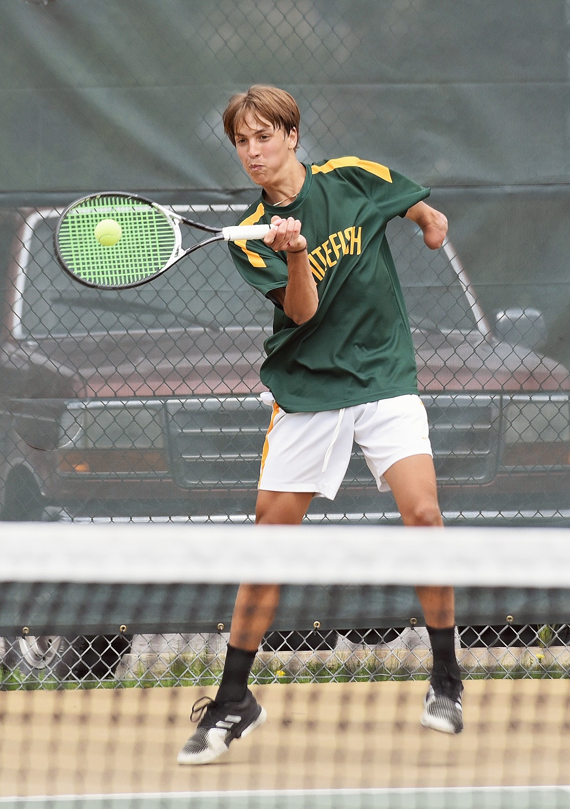 Bulldog Joe Brandt hits a return during a match against Libby on Thursday in Whitefish. (Whitney England/Whitefish Pilot)