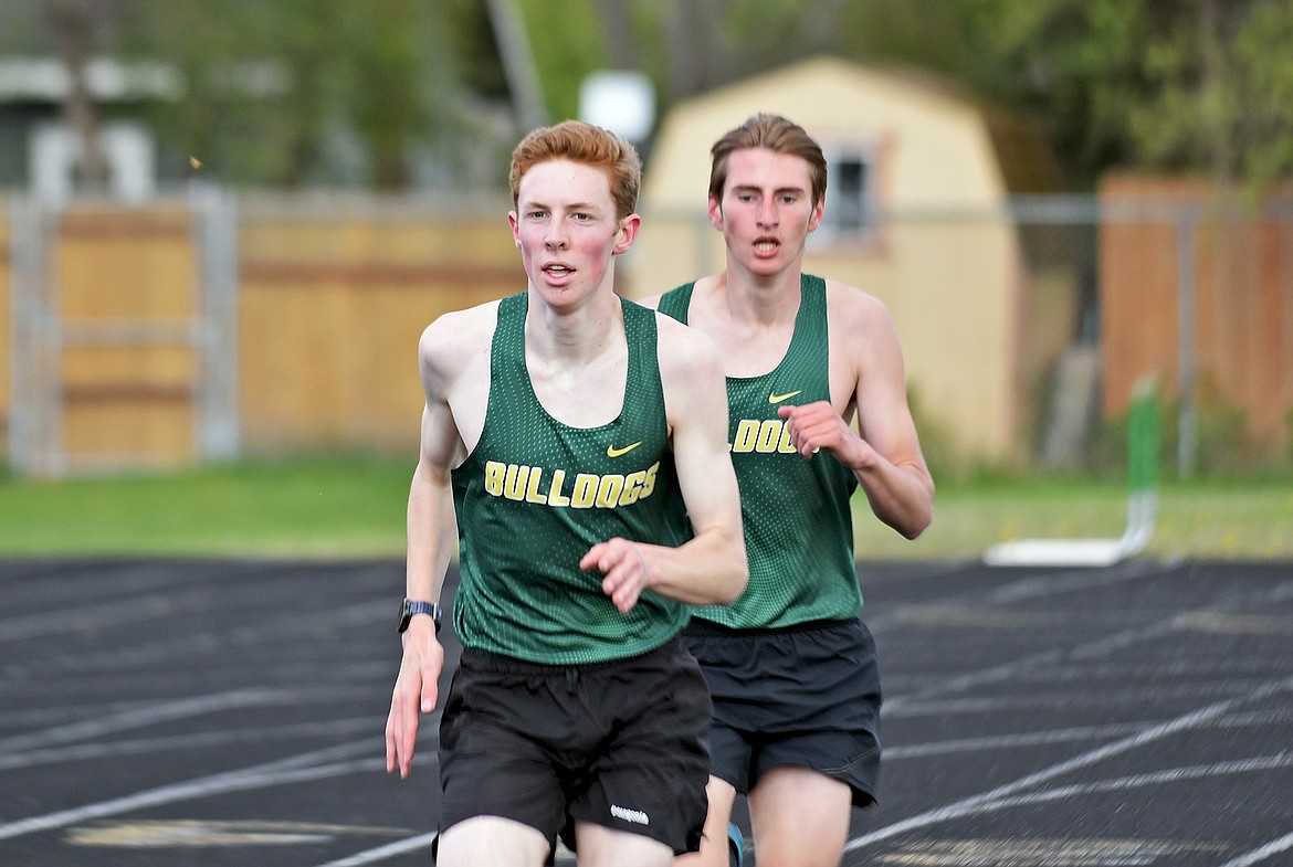 Whitefish's Nate Ingelfinger leads teammate Landon Brown down the last stretch of the boys 1600 meter run at the Whitefish-Flathead track dual on Thursday at WHS. (Whitney England/Whitefish Pilot)