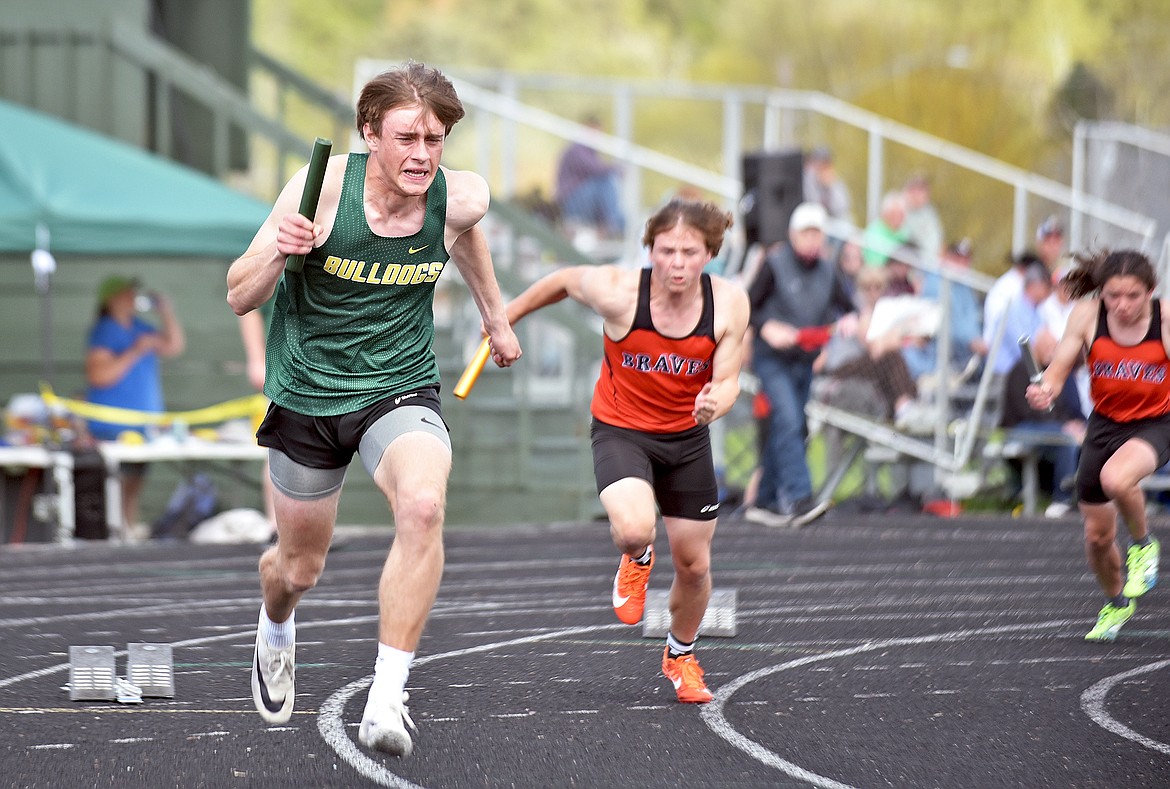 Whitefish junior Bodie Smith sprints at the start of the boys 4X100 meter relay at the Whitefish-Flathead track dual on Thursday at WHS. (Whitney England/Whitefish Pilot)