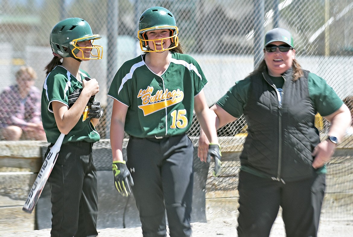 Whitefish freshman Jude Perry celebrates hitting a home run with her teammates and assitant coach in a softball game against Ronan on May 6 in Whitefish. (Whitney England/Whitefish Pilot)