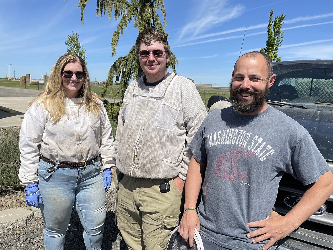 WSU honey bee and pollinator researcher Kelly Kulhanek, graduate student Riley Reed, and Assistant Research Professor Brandon Hopkins at WSU's Honey Bee and Pollinator Research, Extension and Education Facility near Othello. The three were at the center to check on the bess in a number of hives that had just returned from pollination work in California.