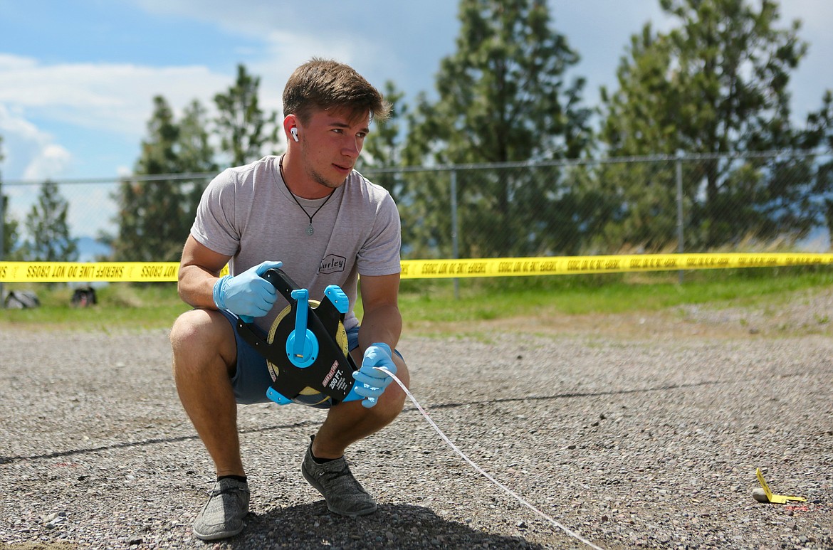 Andrew Olson takes measurements at a mock crime scene near the Bigfork High School football field.
Mackenzie Reiss/Bigfork Eagle