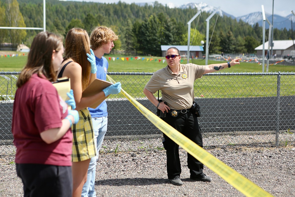 School Resource Officer Paula Sullivan advises students during a mock crime scene activity on Friday, May 14. Students were given various roles during the assignment including swabbing the vehicles for blood, taking photos of the scene, comparing tire impressions and more.
Mackenzie Reiss/Bigfork Eagle