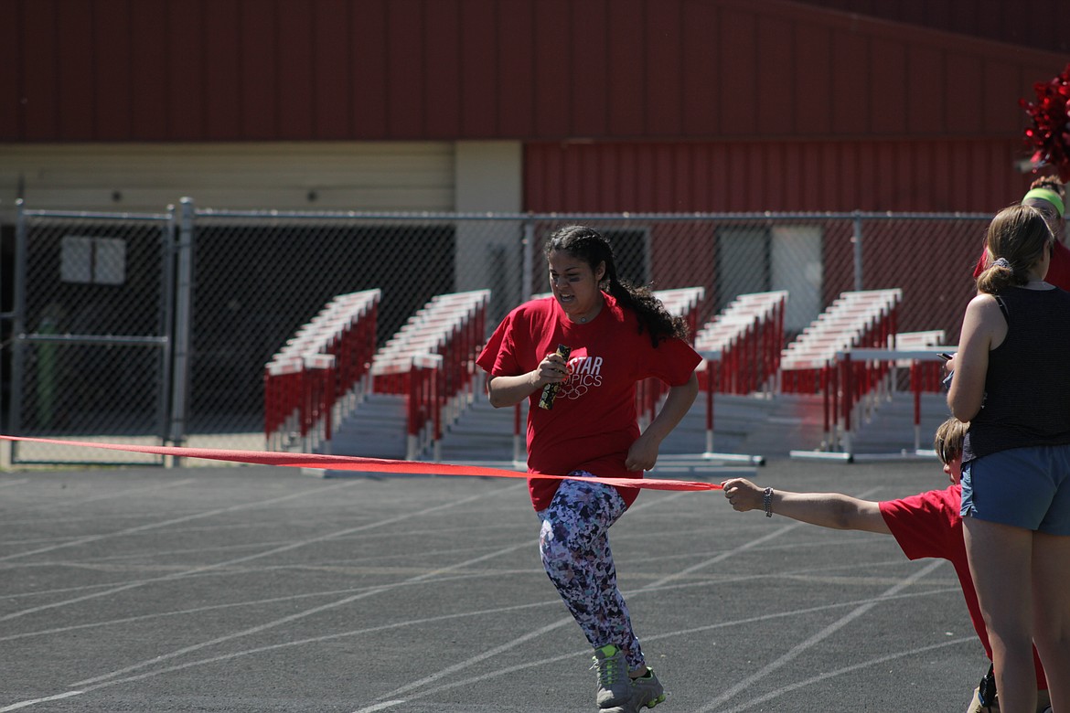 Taylor Carr finishes a relay race at the All Star Olympics Friday.