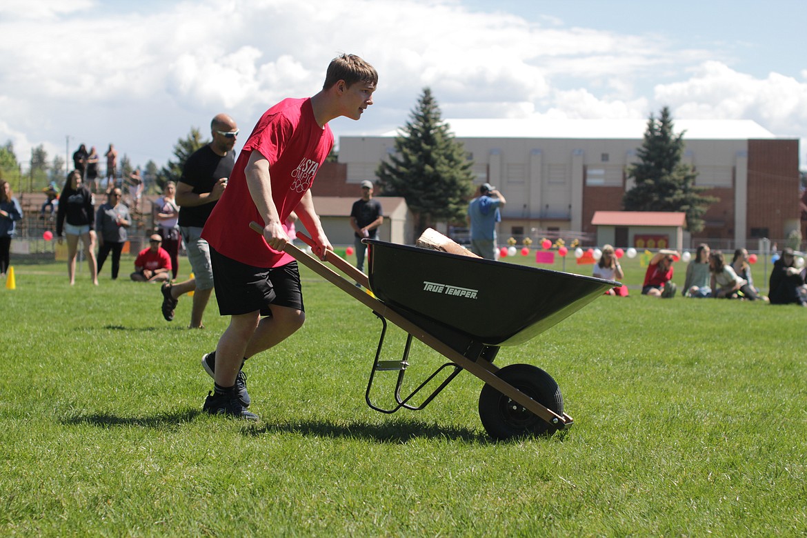 Casey Higgins rolls a wheelbarrow during the obstacle course portion of the All Star Olympics.