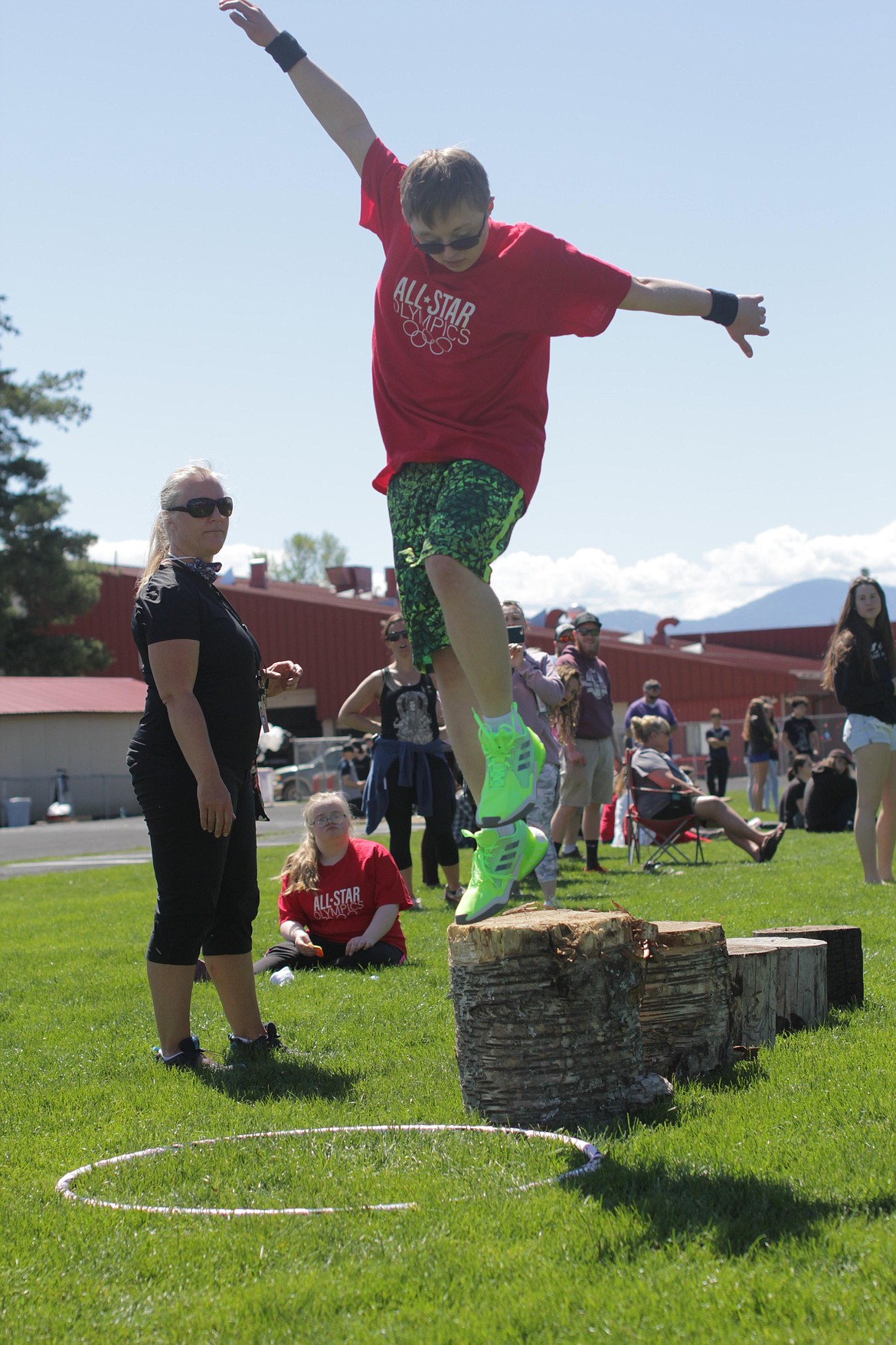 Campbell Wyman jumps off a log at the All Star Olympics obstacle course.