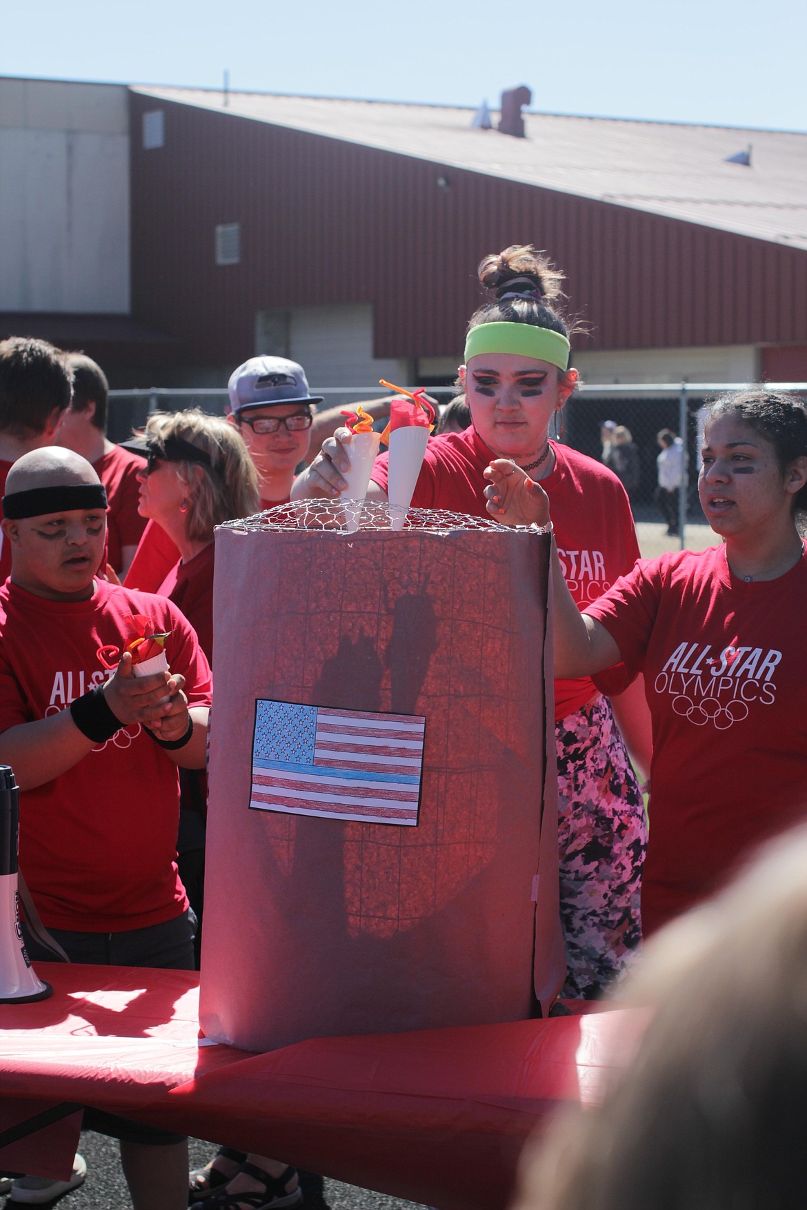 Corban Caralis, Bianca Ackley and  Taylor Carr "light the torch" at the All Star Olympics Friday morning.