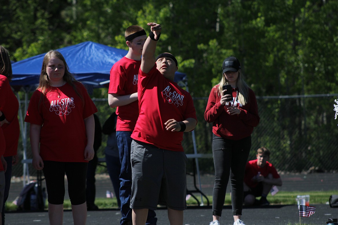 Corban Caralis throws during the shot put event.
