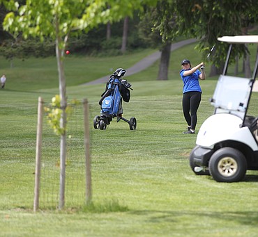 MARK NELKE/Press
Holly Hudson of Coeur d'Alene hits out of trouble on the ninth hole — her final hole of the day — at the state 5A golf tournament at Avondale Golf Club in Hayden Lake.