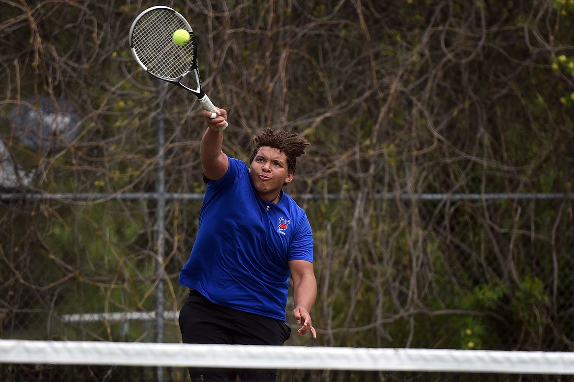 George Brown uses an overhand shot to land a point during action at the divisional tennis tournament in Bigfork Thursday. Brown is one of 16 Bigfork tennis players who advanced to the state tournament in Missoula this week. (Jeremy Weber/Bigfork Eagle)