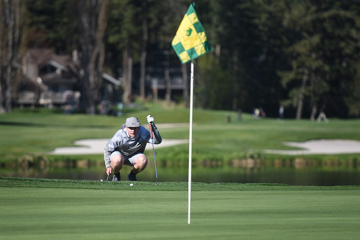 Colin Wade lines up his shot at Eagle Bend Golf Course during the divisional tournament Wednesday. Wade will make the trip to state this week after finishing second at divisionals. (Jeremy Weber/Bigfork Eagle)