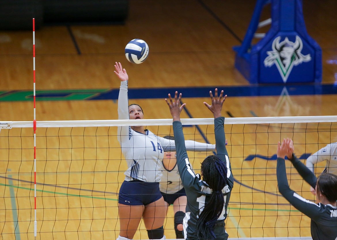 Big Bend’s Tashena Ashby tips the ball over the outstretched hands of the Blue Mountain players on Tuesday afternoon at Big Bend Community College.