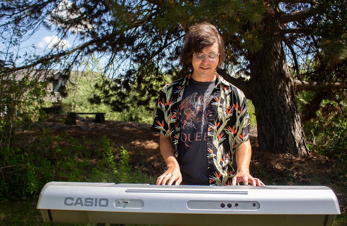 Jeff Ames plays a tune on his keyboard in his backyard in Moses Lake on Tuesday afternoon, the instrument where his love for music was born.
