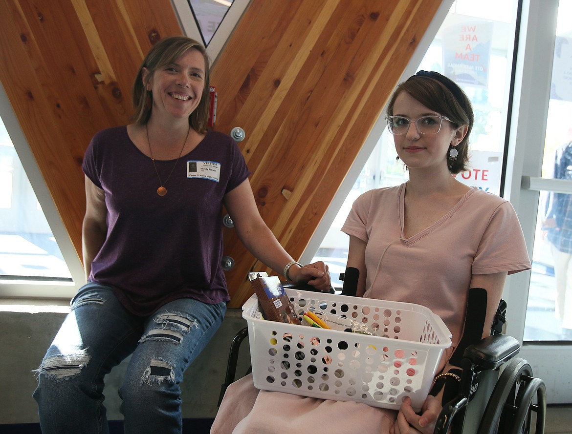 Mom Mindy Roads, left, and daughter Adrienne Roads are pictured May 13 in front of the "Viking V" in Coeur d'Alene High School. Adrienne, who has a series of health conditions, has launched Kindness Crates, a program to bring joy and comfort to other youths with chronic and long-term ailments.