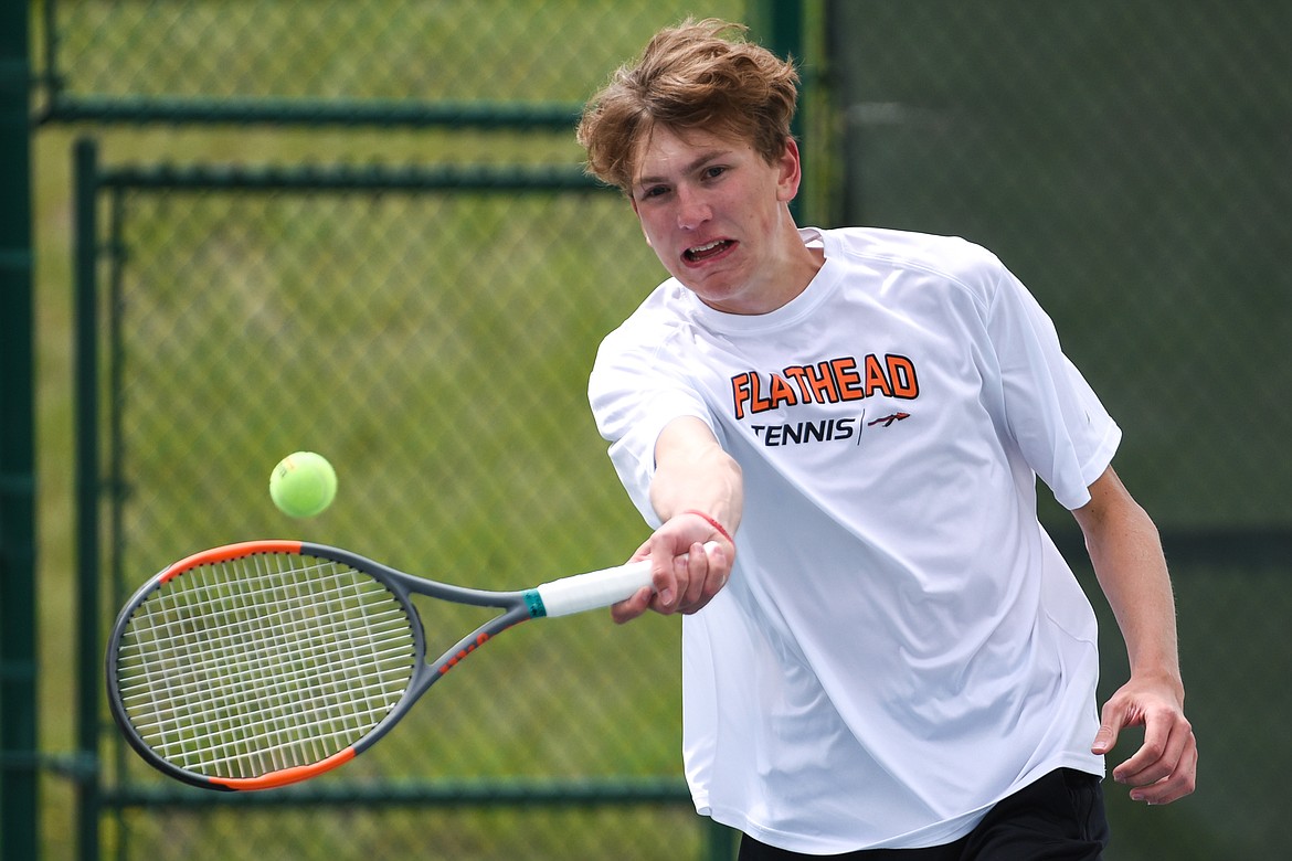 Flathead's Ezra Epperley hits a return in a Round 1 match against Great Falls' Ethan Egan during the Northern AA Divisional Tennis Tournament at Flathead Valley Community College on Thursday. (Casey Kreider/Daily Inter Lake)