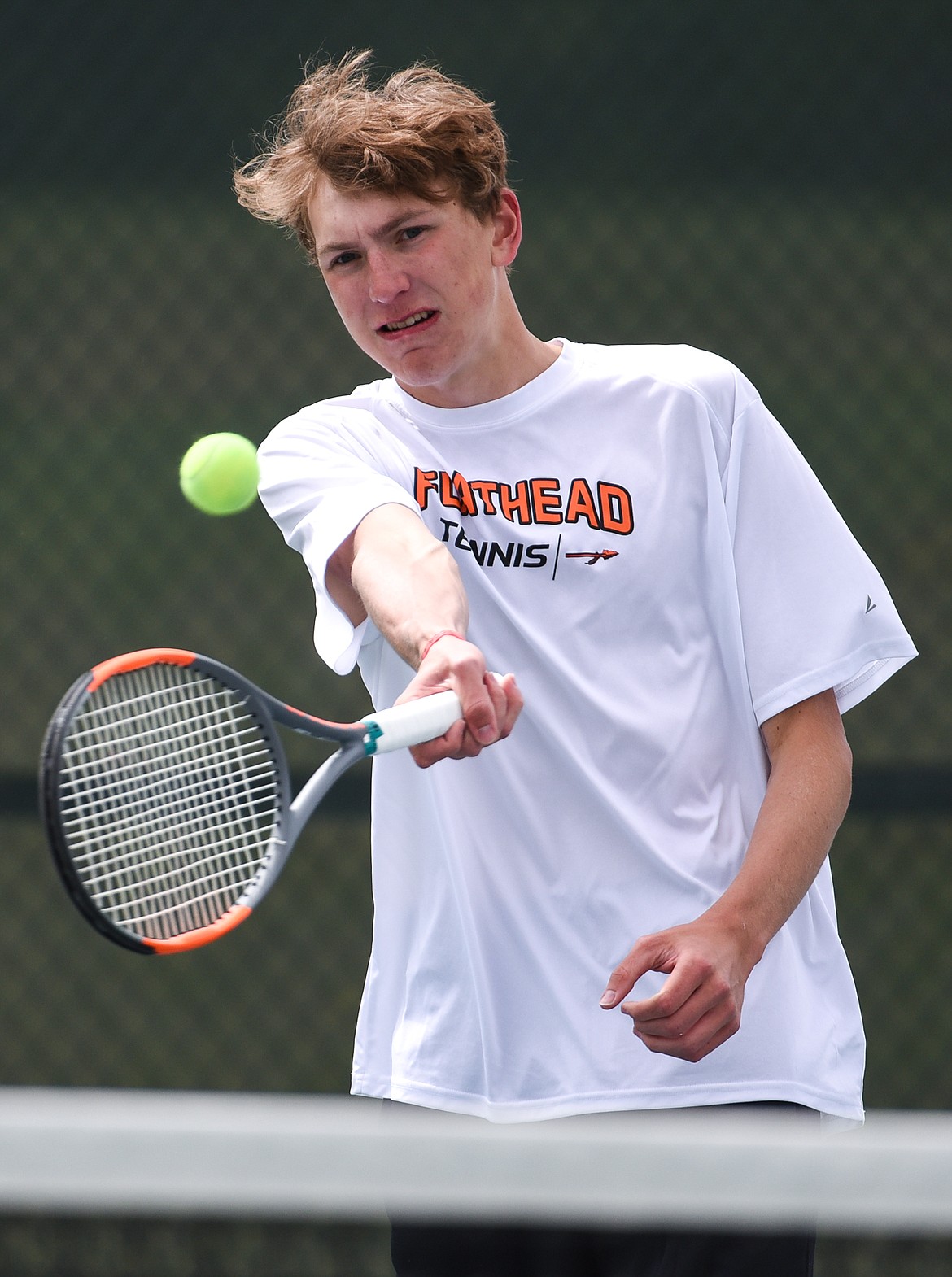 Flathead's Ezra Epperley hits a return in a Round 1 match against Great Falls' Ethan Egan during the Northern AA Divisional Tennis Tournament at Flathead Valley Community College on Thursday. (Casey Kreider/Daily Inter Lake)