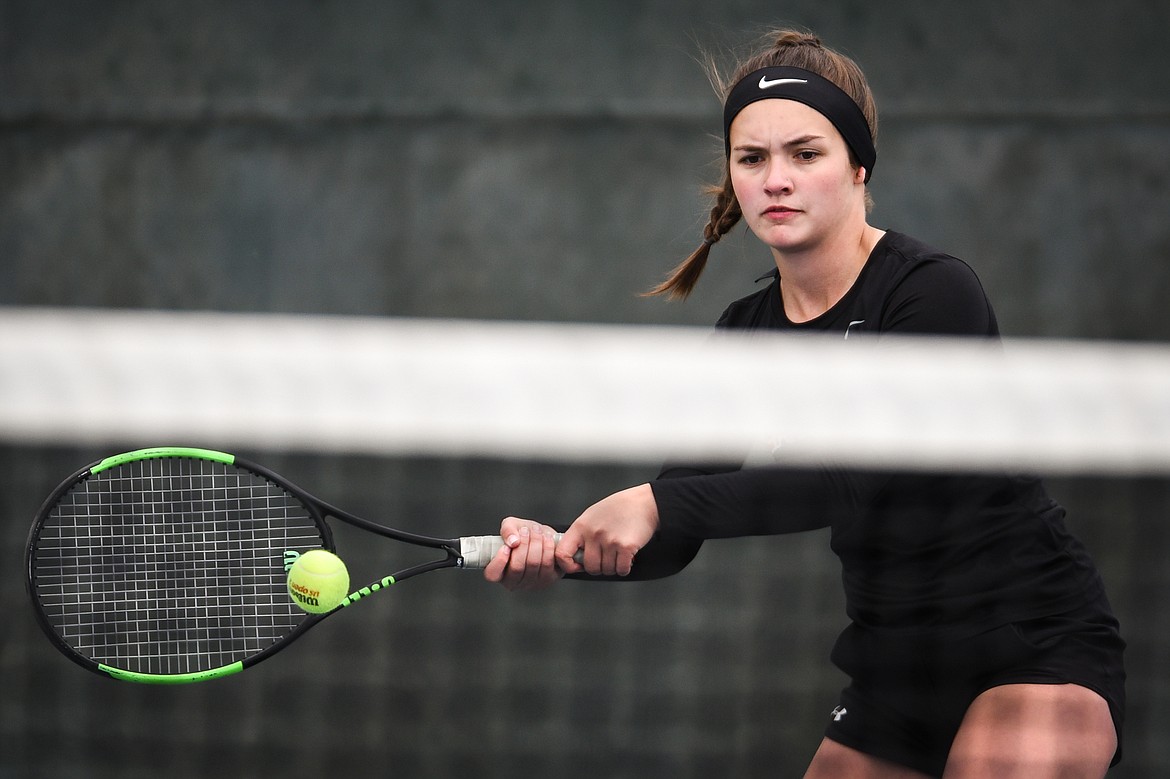 Flathead's Avery Cherot hits a return in a Round 1 match against Great Falls' Christa Holland during the Northern AA Divisional Tennis Tournament at Flathead Valley Community College on Thursday. (Casey Kreider/Daily Inter Lake)