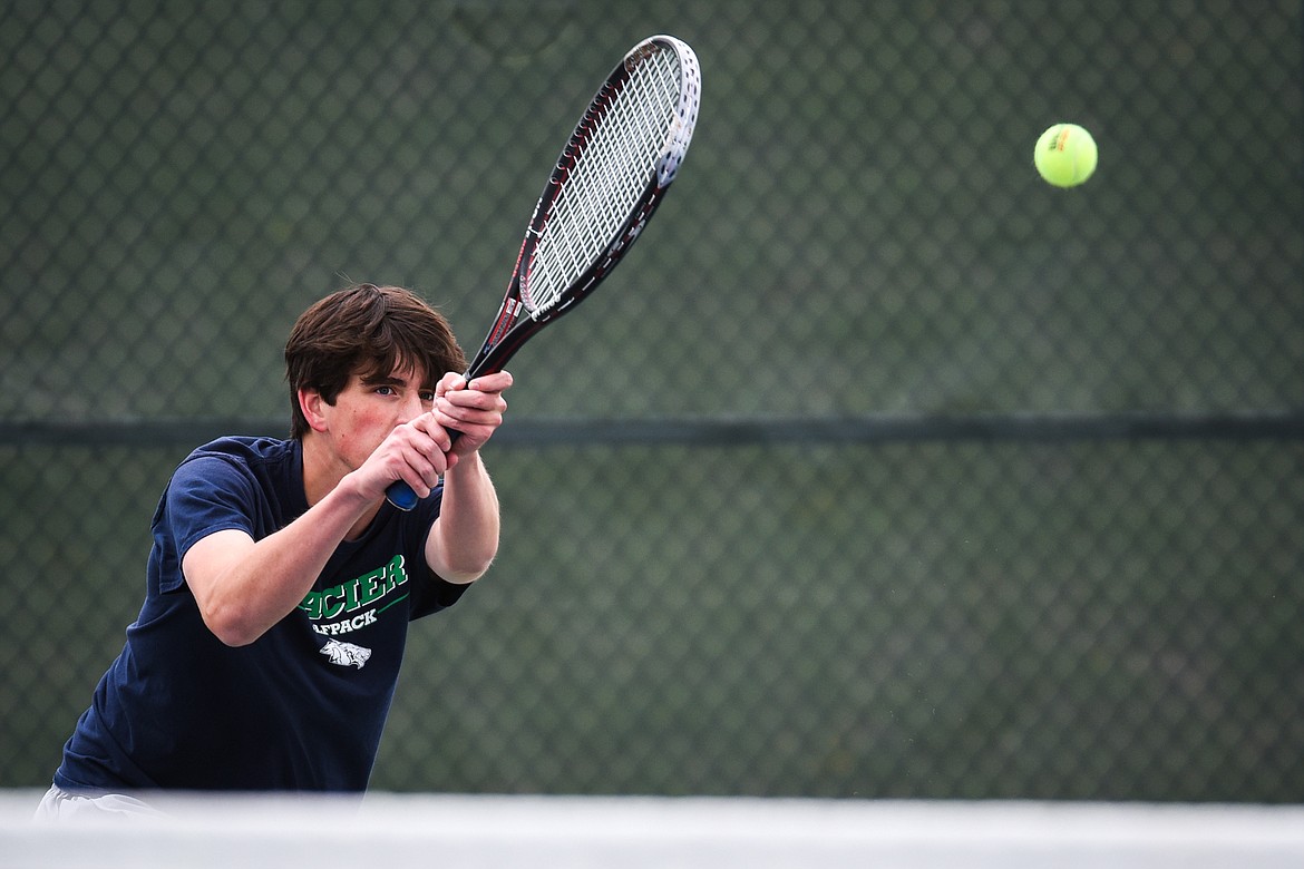 Glacier's Kyler Knutson hits a return in a Round 1 match against Great Falls' Jacob Murray during the Northern AA Divisional Tennis Tournament at Flathead Valley Community College on Thursday. (Casey Kreider/Daily Inter Lake)