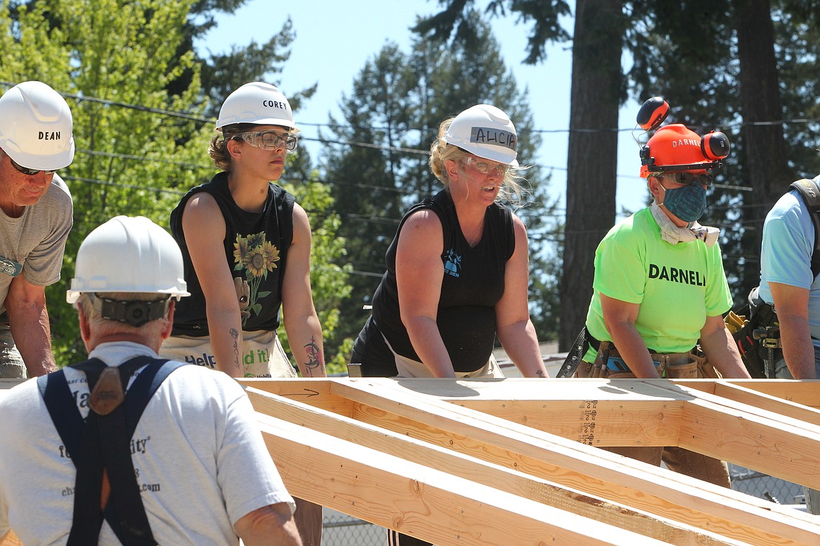 Volunteers with Habitat for Humanity raise the first wall for a home on Klatawah Street in Libby on May 17. (Will Langhorne/The Western News)