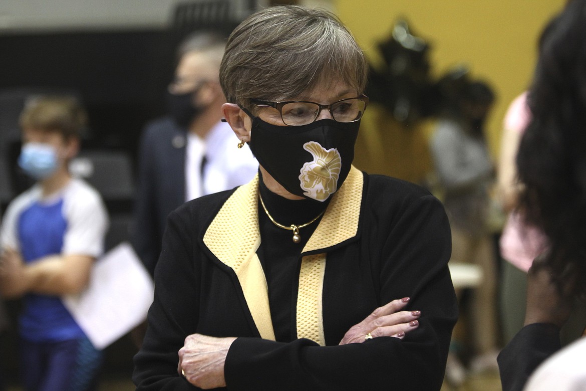 In this Monday, May 17, 2021, photo, Kansas Gov. Laura Kelly tours a COVID-19 vaccination clinic for students aged 12 through 15 set up in a gym at Topeka High School in Topeka, Kan. The Democratic governor is under increasing pressure to end an extra $300 a week in benefits for unemployed workers, with critics of the aid arguing that businesses are having problems hiring enough workers because of it.