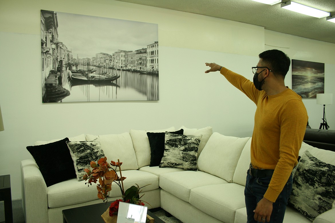 La Imperial Furniture owner Carlos Hernandez, of Moses Lake, explains using color in decoration using a couch, pillows and a photograph.