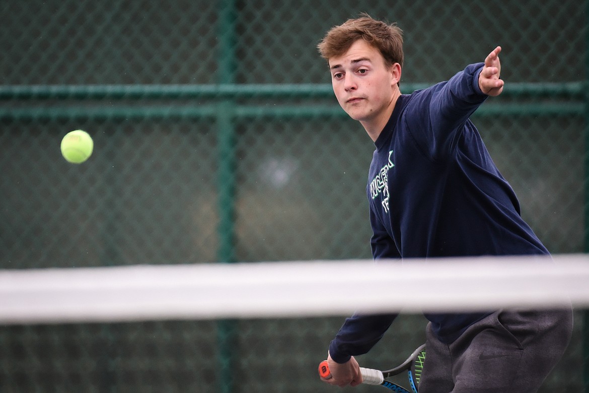 Glacier's Ethan Purdy hits a return in the boys' doubles final with teammate Harrison Sanders against C.M. Russell's Carter Corn and Noah Stimac during the Northern AA Divisional Tennis Tournament at Flathead Valley Community College on Friday. (Casey Kreider/Daily Inter Lake)