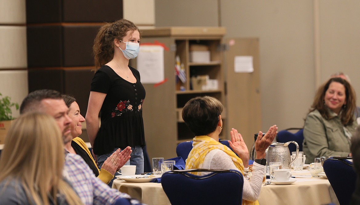 Coeur d'Alene High School valedictorian and Growing the STEM founder Lilian Smith stands as a grant is announced for her nonprofit during the Coeur d'Alene Rotary meeting Friday.