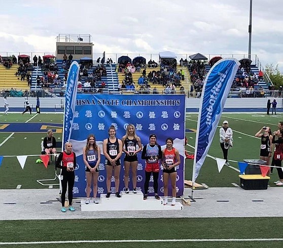 Courtesy photo
Timberlake High senior Jeana Craven, center, and Timberlake junior Reese Yerian, first from center, receive their medals after finishing first and second respectively in the state 3A 200-meter dash on Saturday at Middleton High.