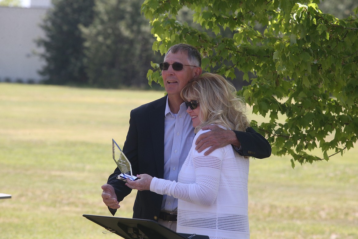 Post Falls School Superintendent Jerry Keane accepts an award and an embrace from Kootenai County Task Force on Human Relations President Christie Wood Saturday. "It was an opportunity to tell these people how important they are to the community," Wood said. "We didn't want to wait another year. These awards were from last year. For us, we want to recognize people who work so hard for human rights and civil rights all the time. We didn't want to wait any longer." (CRAIG NORTHRUP/Press)