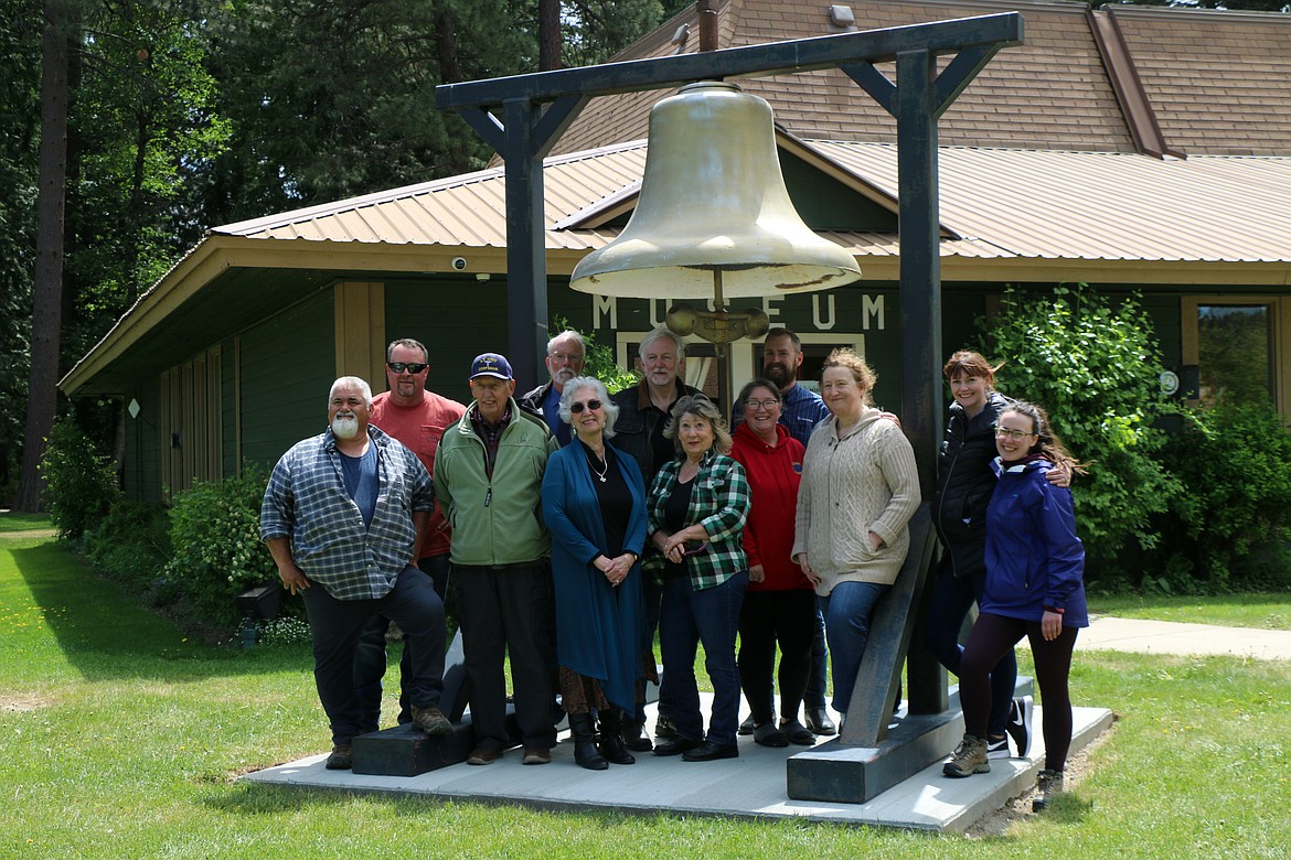 A group of volunteers and community residents involved with bringing the city's historic bell back home pose for a photo after the bell was installed outside the Bonner County Historical Museum in Lakeview Park.